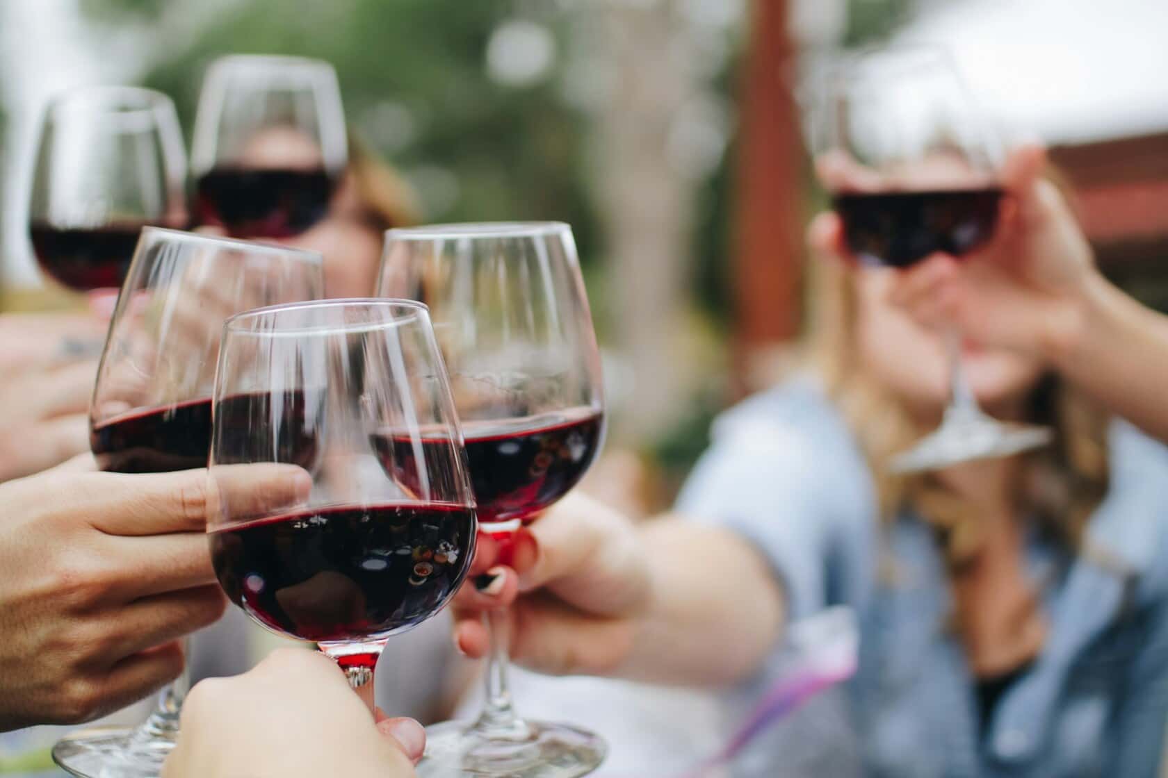 Glasses raised over a tasting table