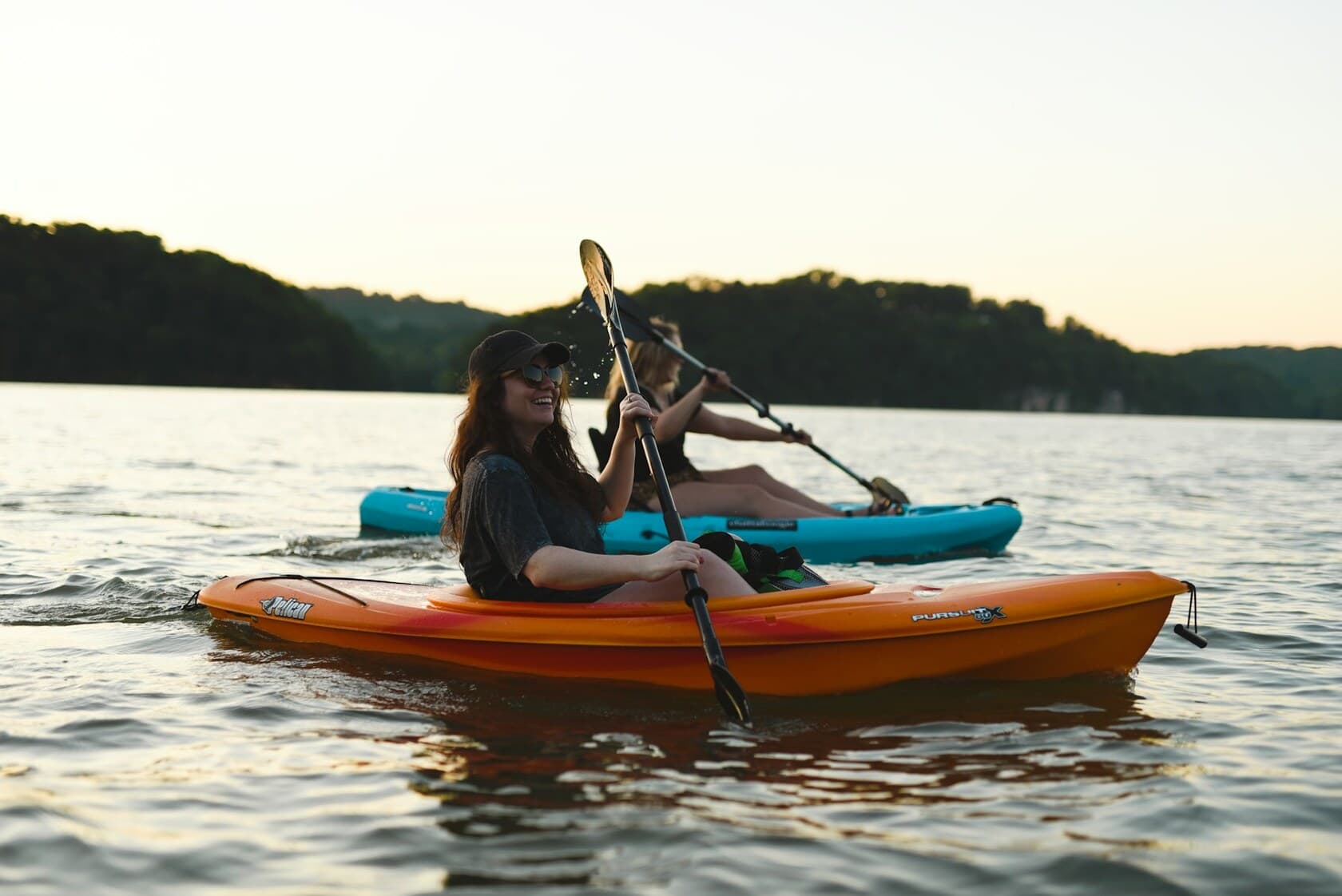 A kayaker paddling at golden hour